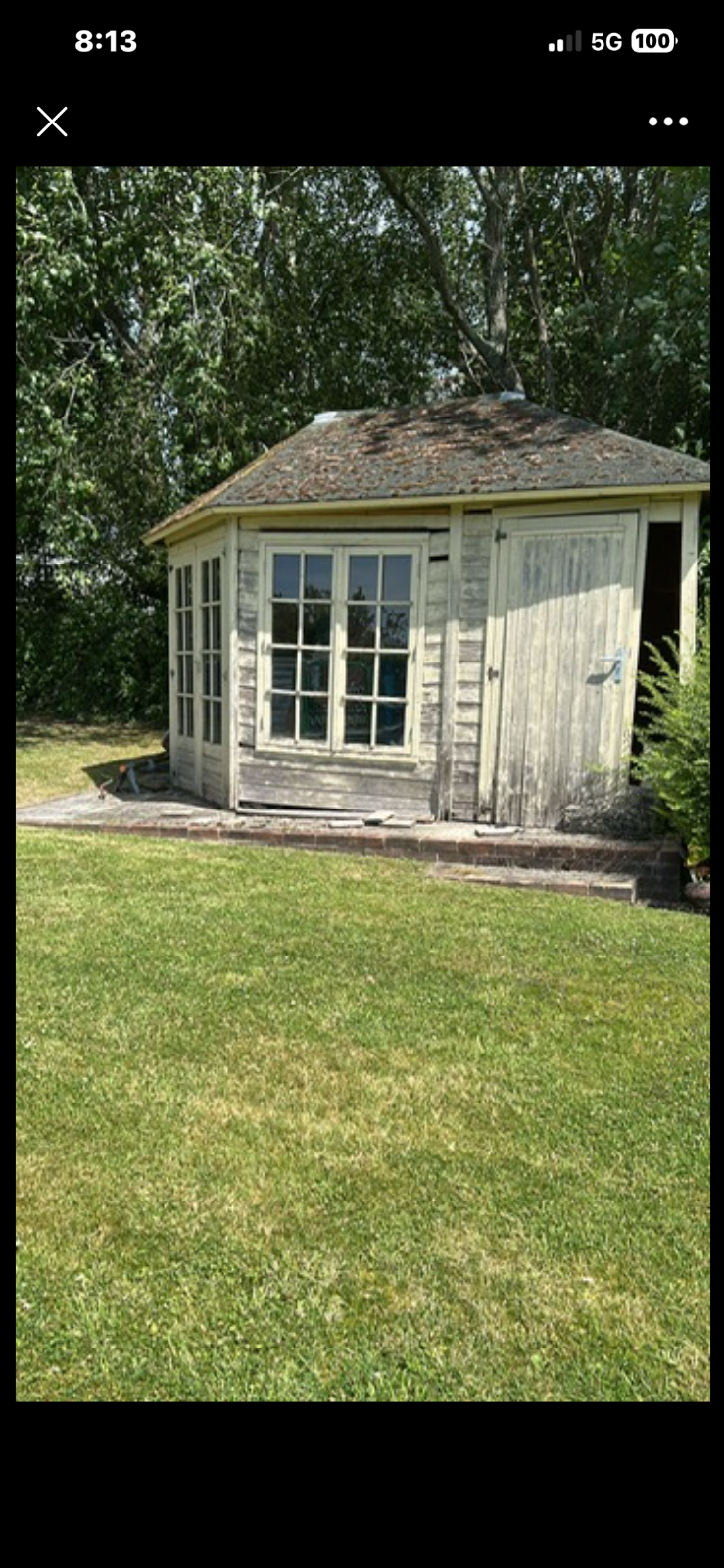 Professional waste clearance team dismantling an old wooden garden shed in a Gosport residential garden