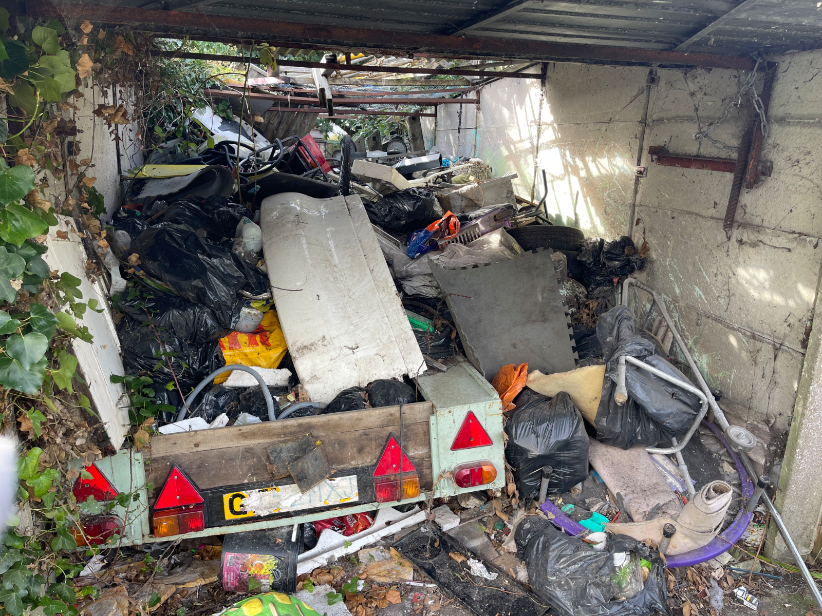 A cluttered garage in Havant before a professional garage clearance service.