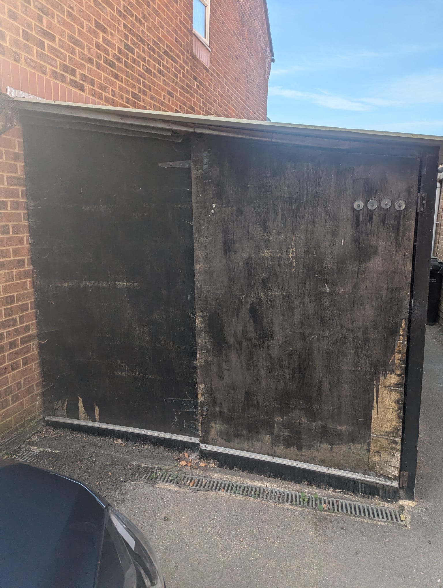Before and after of a garage demolition in Portchester, showing the old timber garage and the clear space after removal.