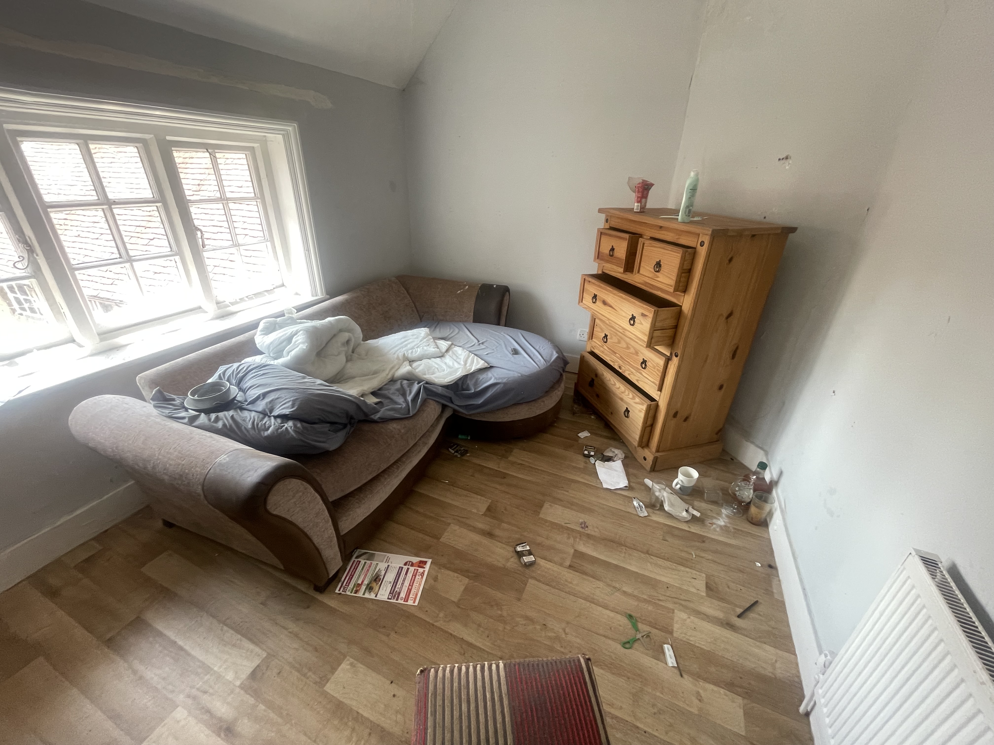 Before and after photos of a house clearance in a Portsmouth flat, showing cluttered rooms cleared to be empty and clean.